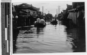 People traveling by boat on floodwaters, Peng Yang, Korea, ca. 1920-1940