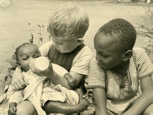 Jean-Luc Gambier feeding a baby, in Ebeigne, Gabon