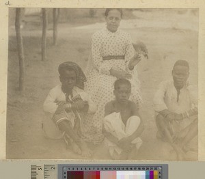 Woman with parrot and three boys, Malawi, ca.1895