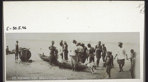 Cameroonians on the beach at Bonaku. (Boat and a barrel)