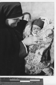 Sister Rose and an orphan at Fushun, China, 1938