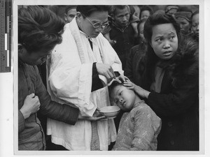 Fr. Chan baptizing in Wuzhou, China, 1947