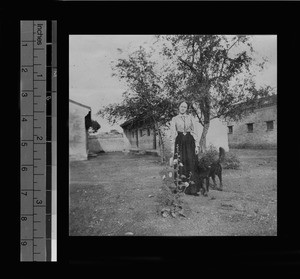 Miss Young with her dog outside Methodist sanatorium for girls, China, 1897