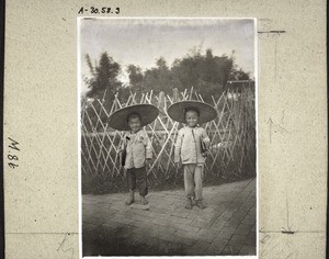 Boys with hats made of bamboo