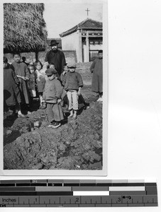 Fr. Maurice Ahern with children in Meixien, China, 1929