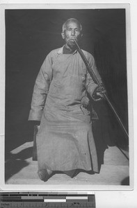 An elderly man with a long pipe at Luojing, China, 1934