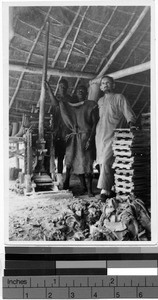 Two men and a Priest with a tile press, Africa, August 1948