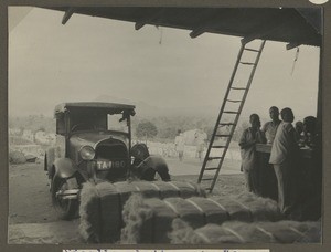 Bales of sisal in front of a car, Ndungu, Tanzania, ca.1929-1940