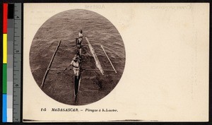 Two men piloting an outrigger canoe, Madagascar, ca.1920-1940