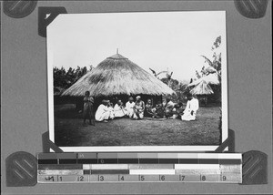 Christians in front of a hut, Mbozi, Tanzania