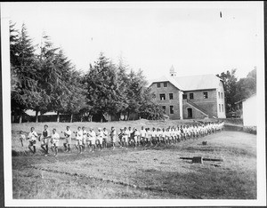 Students of the teachers' seminar marching on a meadow, Marangu, Tanzania, ca.1927-1933