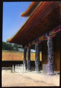 Ground view of a temple with tiled roof and carved pillars, China, ca.1917-1923