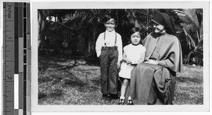 Sr. Agnes Marie, MM, with two newly baptized children, Kalihi, Honolulu, Hawaii, 1946