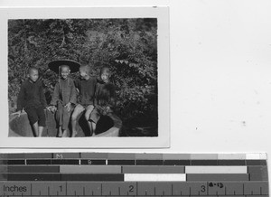 Boys sitting on the well at Zhongxin, China, 1939