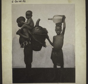 Children of Chief Ajwe in Nyasoso, Cameroon. The 9-year old girl has a carrying strap around her forehead and wears a brightly coloured cloth as a sign of mourning