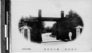 Man standing guard at a gate, Japan, ca. 1920-1940