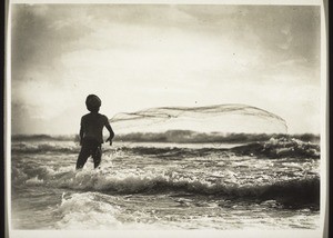 A fisherman throws out his net