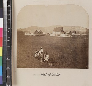 Missionary being carried by filanjana through fields, west of Antananarivo, Madagascar, ca. 1865-1885