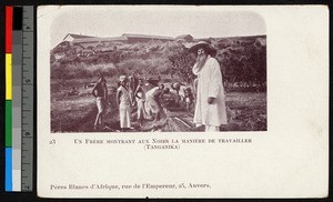 Missionary father with men working outdoors, Tanzania, ca.1920-1940