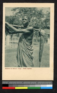 Man carrying fish on oar, Congo, ca.1920-1940