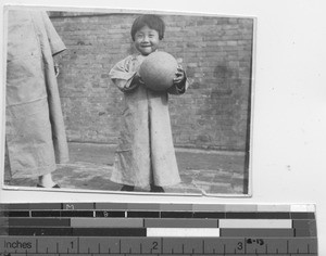 Young orphan with ball at Fushun, China, 1933