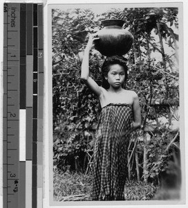 Girl carrying water jar on her head, Philippines, 1928