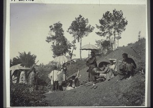 Venerating the ancestors at their grave with music, sacrifice and prayer