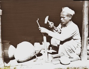 Craftsman making vessels, India, ca. 1930