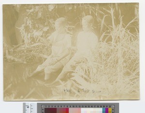 Boys seated on a river embankment, Malawi, ca.1910