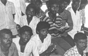 Jeypore, Orissa, India. Worship Service at Roghumonipur. The verandah is crowded, with men and