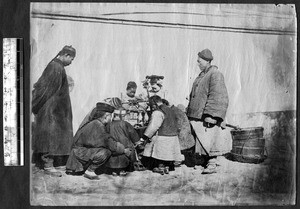 Group of people around vendor, Beijing, China, ca.1870-1880