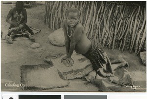 Girl grinding corn, South Africa