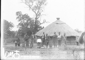 African people in front of a hut, Mozambique, ca. 1896-1911