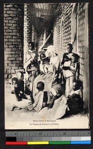 Missionary sister and children reading outdoors, Uganda, Africa, ca.1920-1940