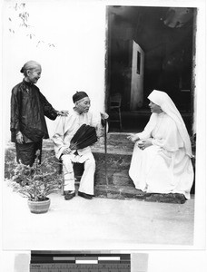 Maryknoll Sister talking to elderly couple, Kaying, China, 1949