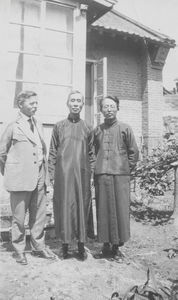 Christen Christensen and two Chinese priests, Yen Pao Ting and Chü Yen-K'uei, outside the woman