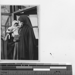 Maryknoll Sister with orphan at Fushun, China