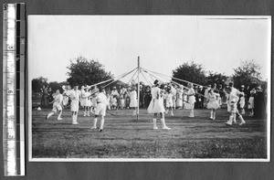 Children dancing the May pole, Jinan, Shandong, China, 1924