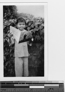 An orphan singing Christmas carols at Luoding, China, 1936