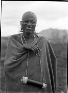 African man wearing an object on a string around his neck, Tanzania, ca.1893-1920