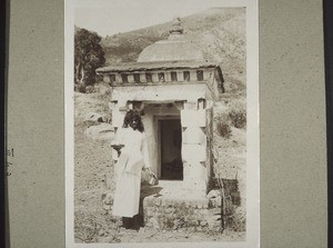 An Indian mountain-dweller in front of his holy place bringing an offering