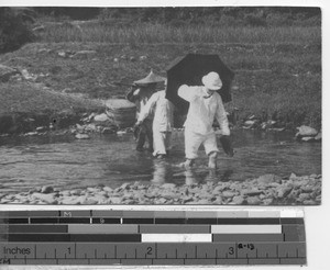 Fr. Toomey crossing a stream at Pingnan, China, 1932