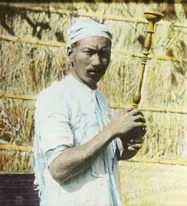 Man with wood-turned object, India, ca. 1920