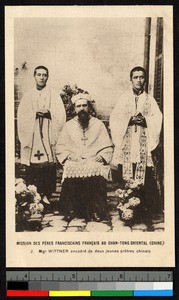 A photographic portrait of two Chinese and one Western priest in a courtyard, China, ca. 1920-1940