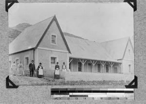 Five women and a man in front of a residential building, Goedverwacht, South Africa