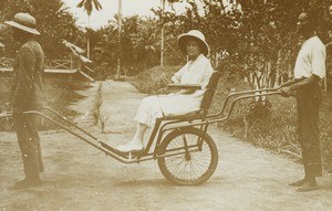 Female missionary in rickshaw, Congo, c. 1920-1930