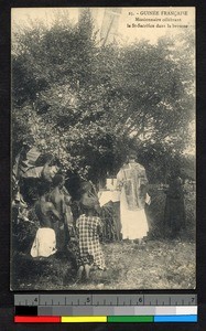 Catholic priest celebrating Mass outdoors, Guinea, ca.1920-1940