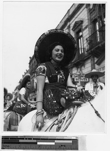 Smiling woman riding a horse sidesaddle, Guadalajara, Mexico, ca. 1942