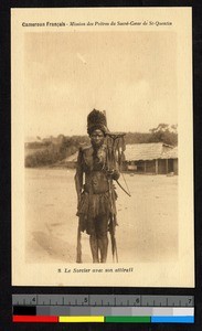 Priest of indigenous religion with accoutrements, Cameroon, ca.1920-1940