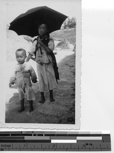 Three children walking along a path in Stanley, Hong Kong, China, 1937